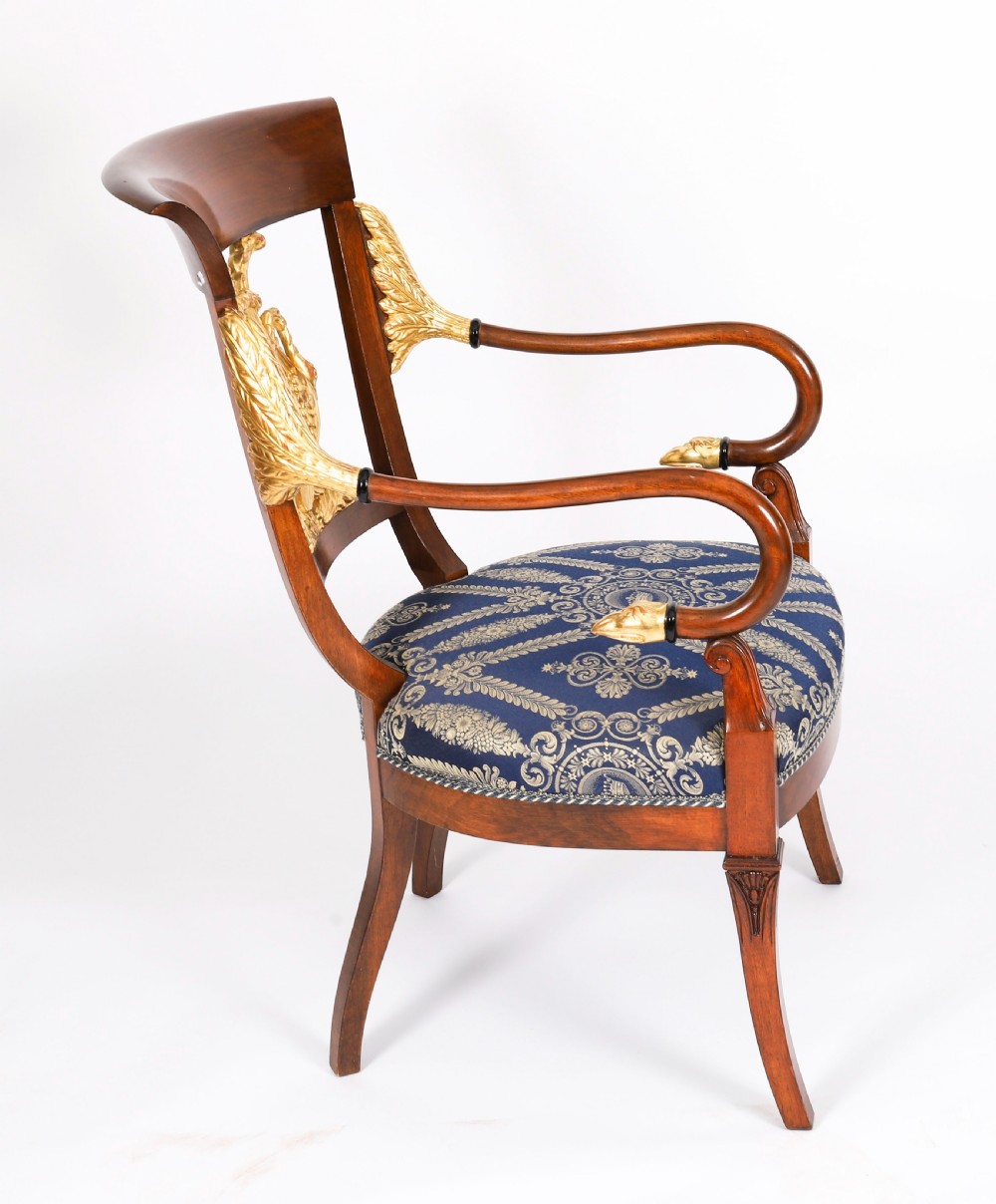 A pair of Italian Neoclassical armchairs featuring dark wood frames with giltwood swan carved back splats and blue patterned upholstered seats. View III