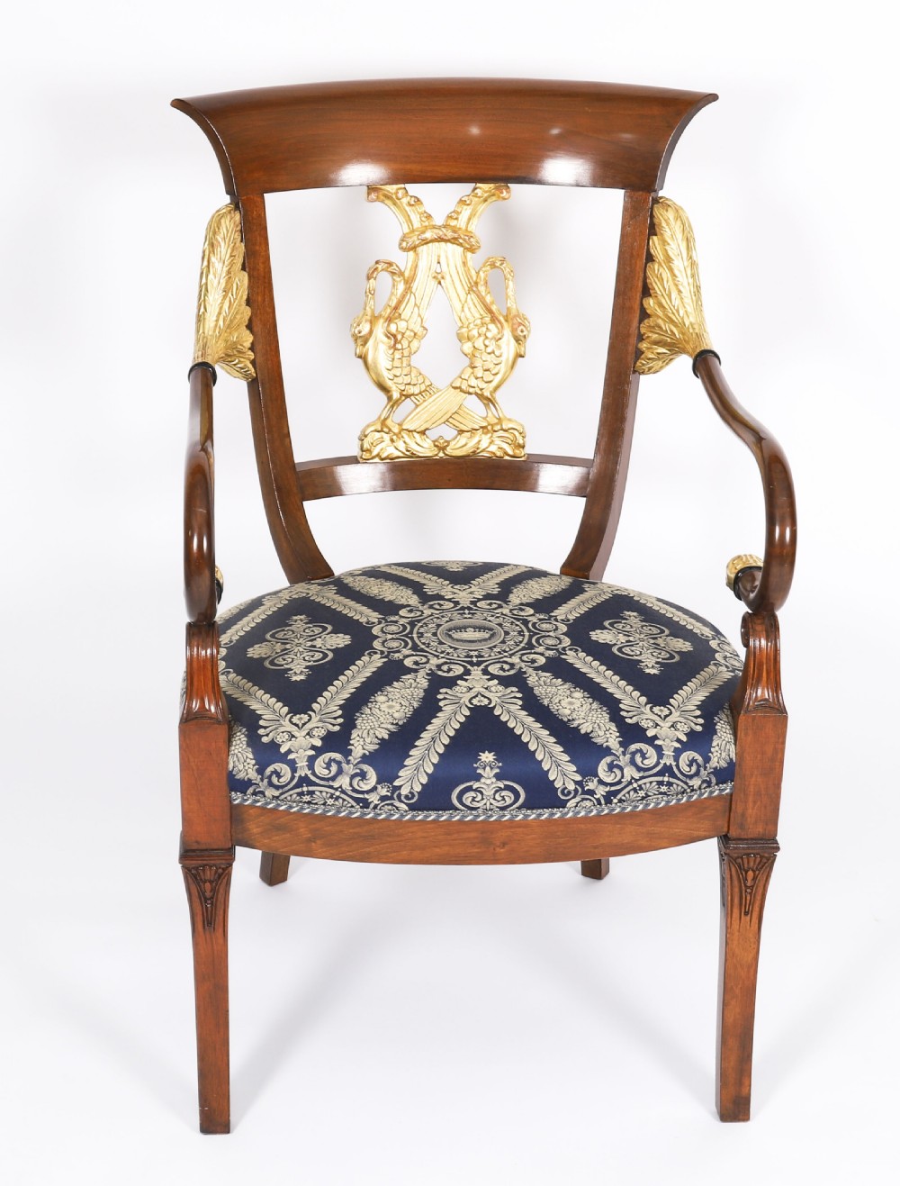 A pair of Italian Neoclassical armchairs featuring dark wood frames with giltwood swan carved back splats and blue patterned upholstered seats. View V