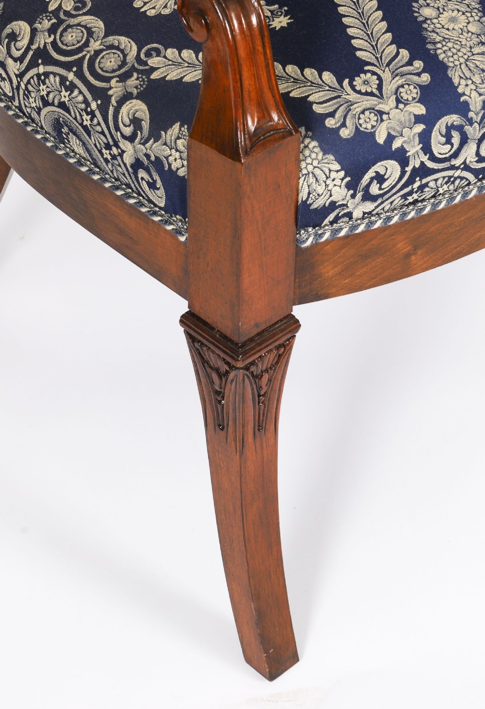 A pair of Italian Neoclassical armchairs featuring dark wood frames with giltwood swan carved back splats and blue patterned upholstered seats. View VII
