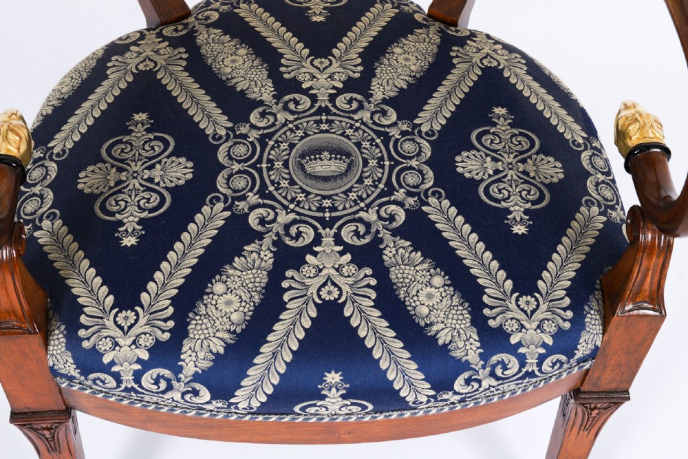 A pair of Italian Neoclassical armchairs featuring dark wood frames with giltwood swan carved back splats and blue patterned upholstered seats. View XI