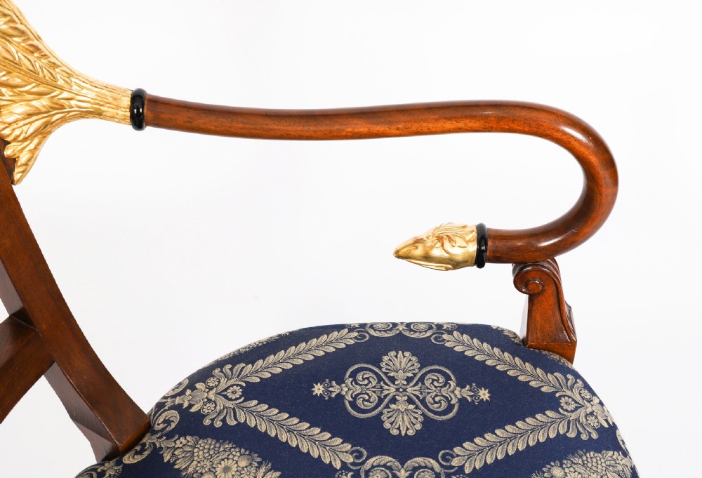 A pair of Italian Neoclassical armchairs featuring dark wood frames with giltwood swan carved back splats and blue patterned upholstered seats. View XIV