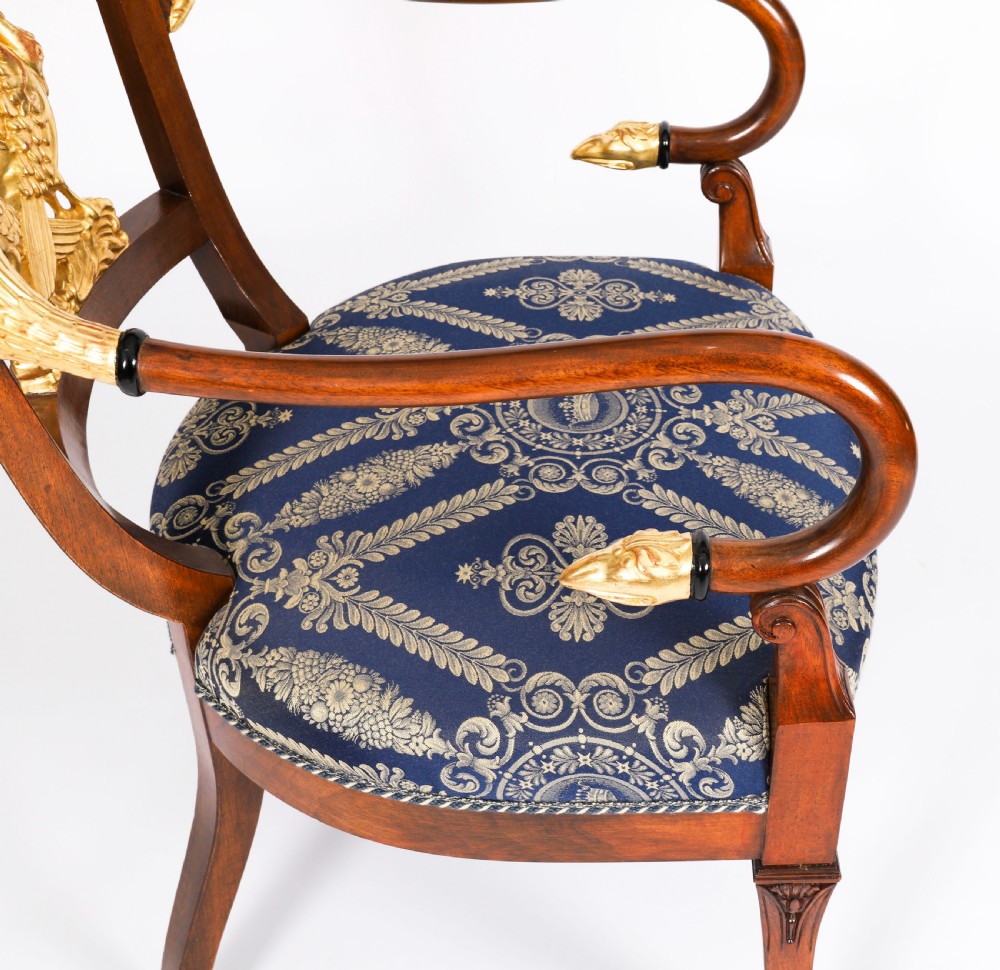 A pair of Italian Neoclassical armchairs featuring dark wood frames with giltwood swan carved back splats and blue patterned upholstered seats. View XV