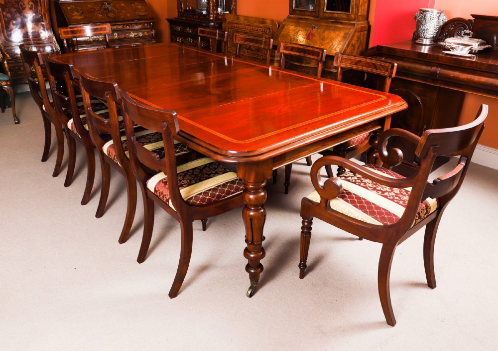 A 19th-century William IV flame mahogany extending dining table set on turned legs with brass castors. View III