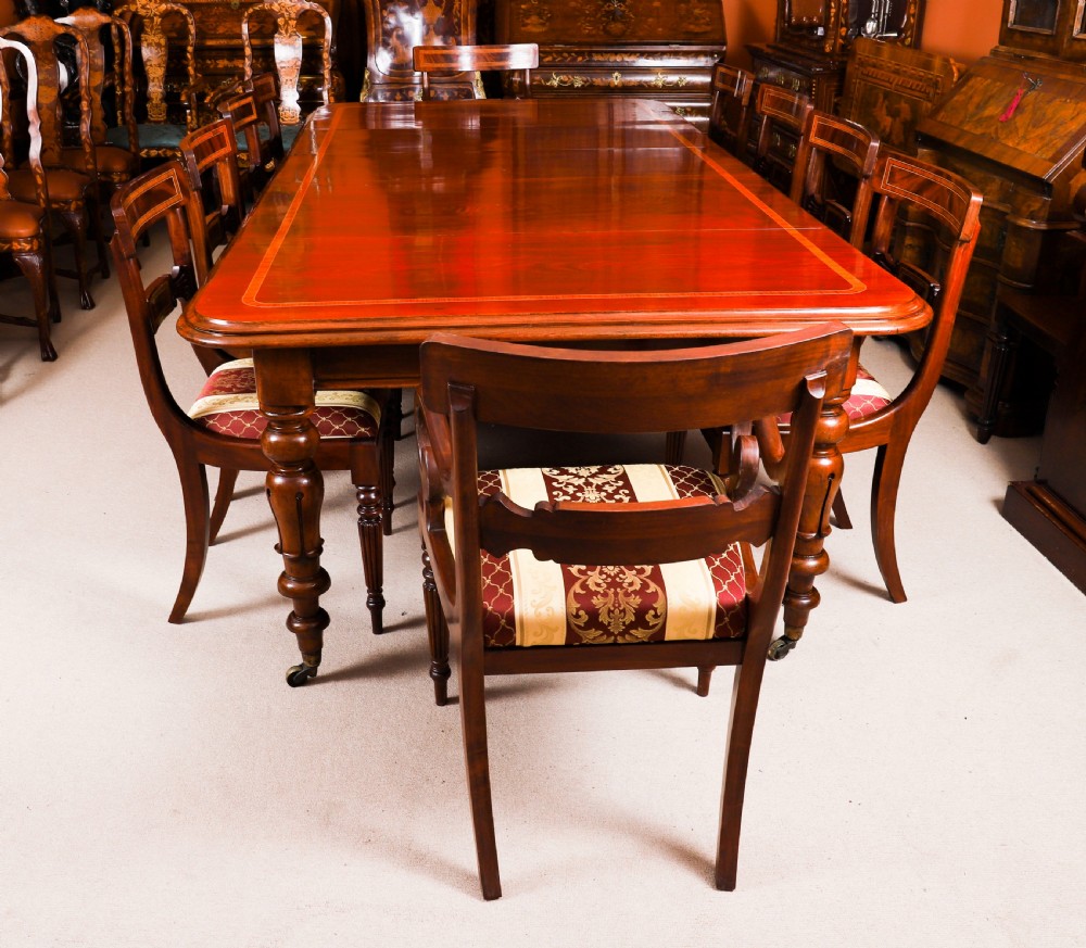 A 19th-century William IV flame mahogany extending dining table set on turned legs with brass castors. View IV