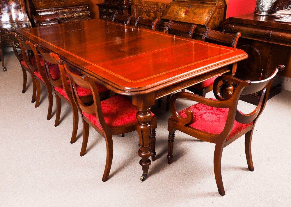 A 19th-century William IV flame mahogany extending dining table set on turned legs with brass castors. View V