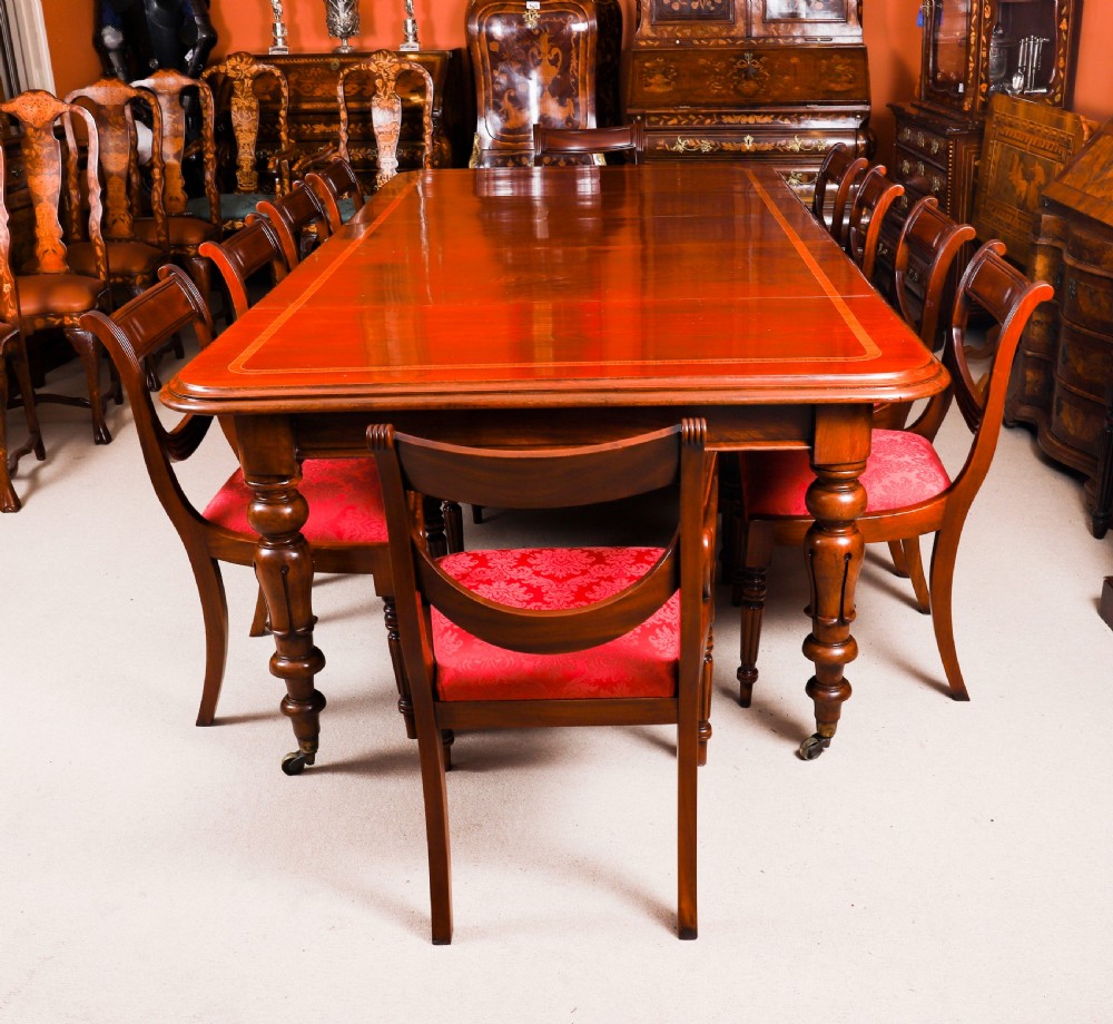 A 19th-century William IV flame mahogany extending dining table set on turned legs with brass castors. View VI