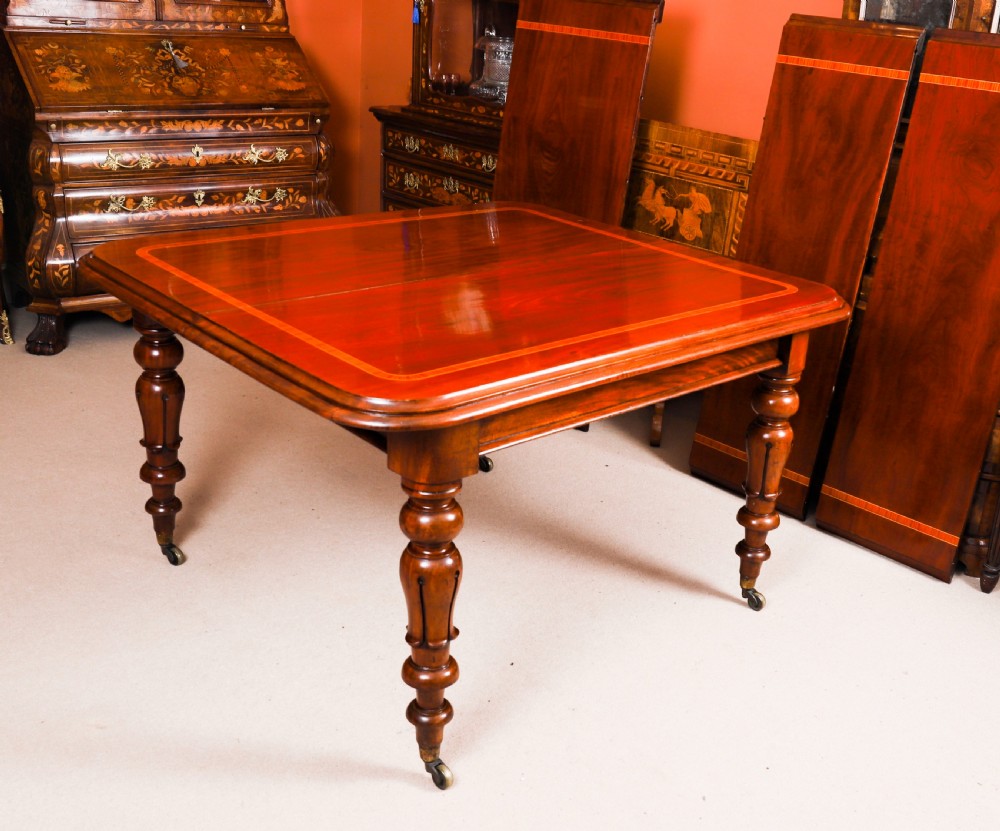 A 19th-century William IV flame mahogany extending dining table set on turned legs with brass castors. View IX