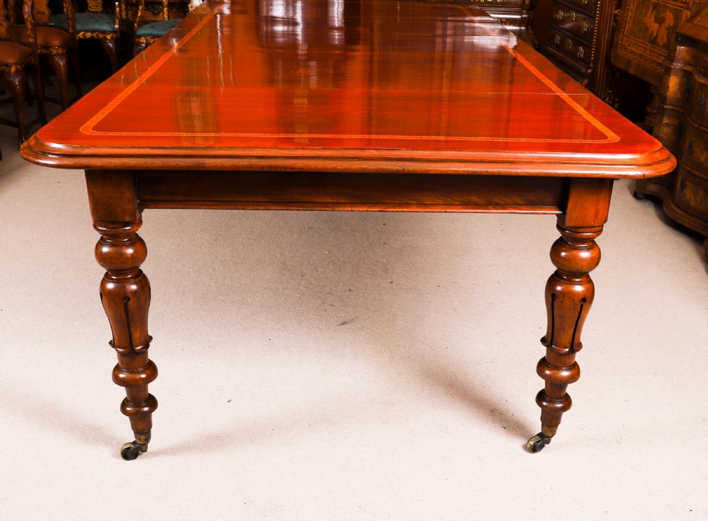 A 19th-century William IV flame mahogany extending dining table set on turned legs with brass castors. View XI