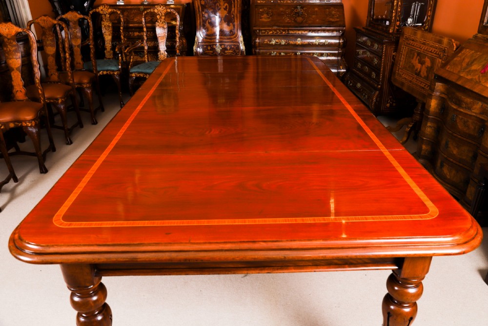 A 19th-century William IV flame mahogany extending dining table set on turned legs with brass castors. View XII