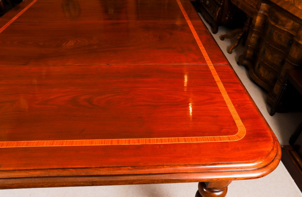 A 19th-century William IV flame mahogany extending dining table set on turned legs with brass castors. View XV