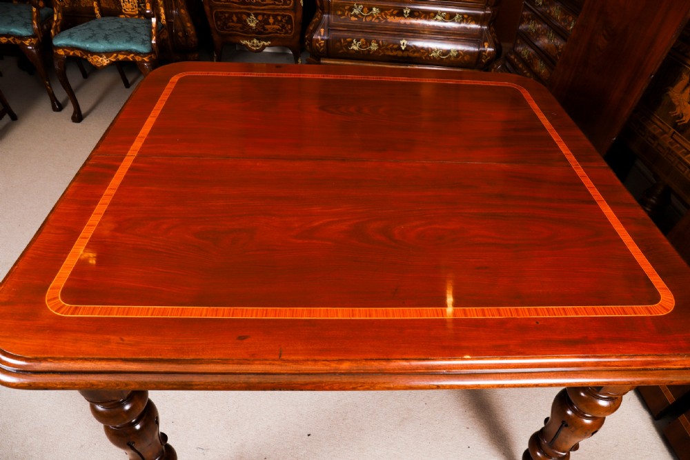 A 19th-century William IV flame mahogany extending dining table set on turned legs with brass castors. View XVI
