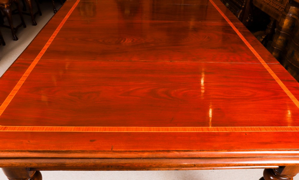 A 19th-century William IV flame mahogany extending dining table set on turned legs with brass castors. View XIX