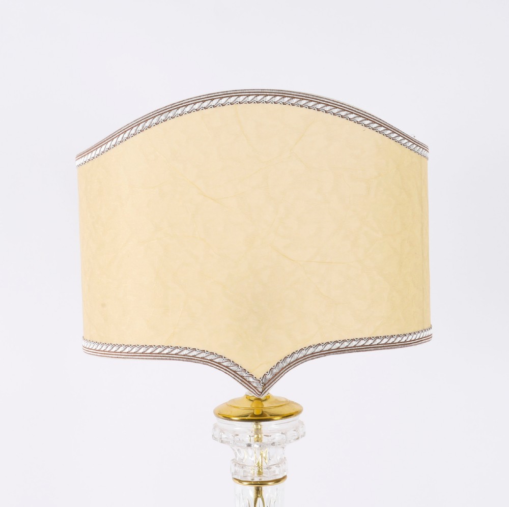 A pair of Art Deco table lamps featuring fluted clear glass column stems on square gilded metal bases with arched cream lampshades. View IV