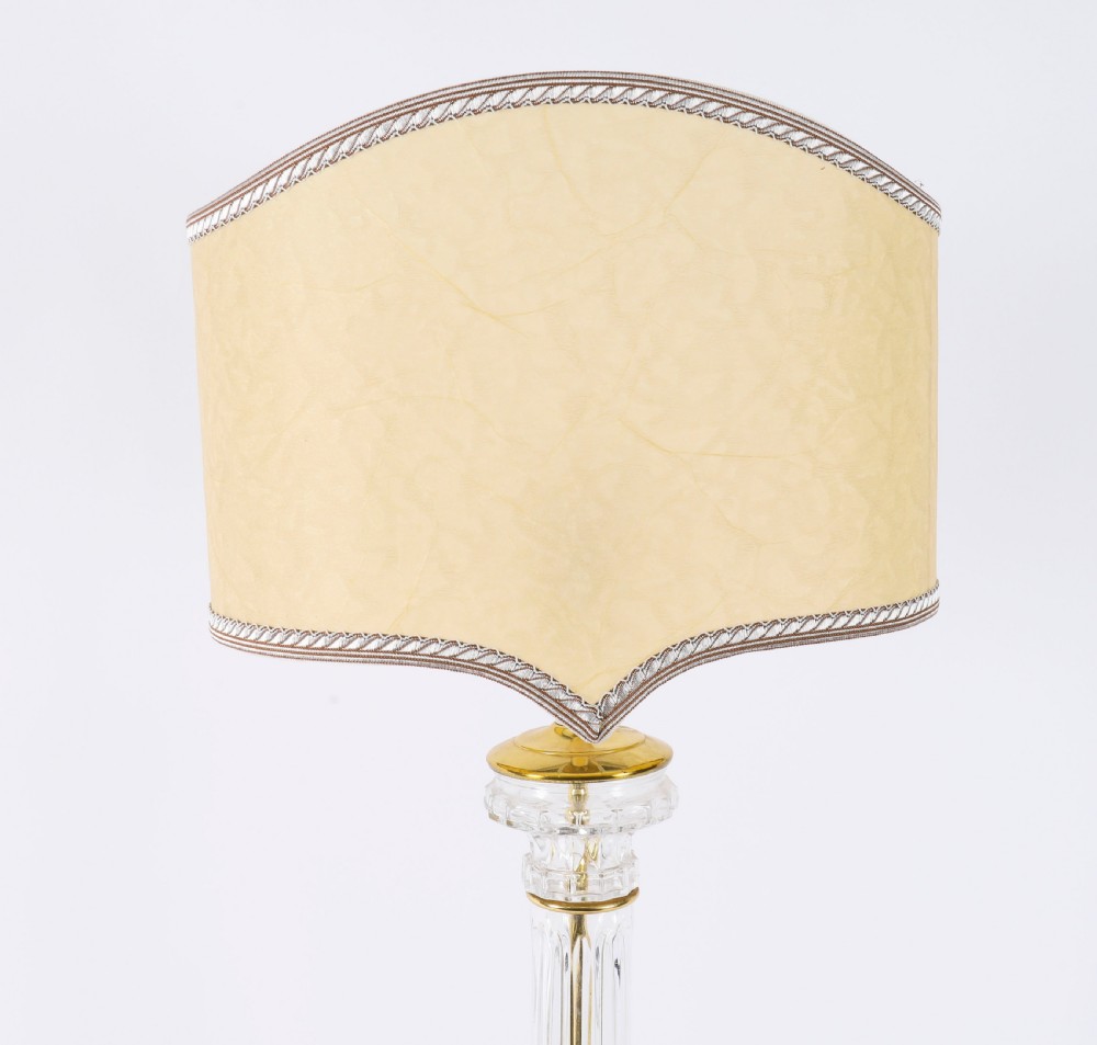 A pair of Art Deco table lamps featuring fluted clear glass column stems on square gilded metal bases with arched cream lampshades. View IX