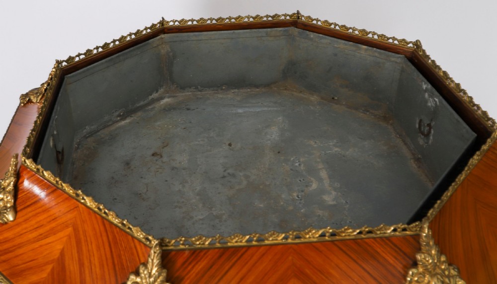 An octagonal kingwood display cabinet featuring chevron parquetry veneers, gilt bronze mounts, and glazed panels housing internal glass shelves. View VIII