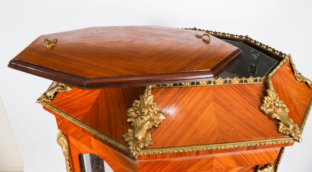 An octagonal kingwood display cabinet featuring chevron parquetry veneers, gilt bronze mounts, and glazed panels housing internal glass shelves. View XI