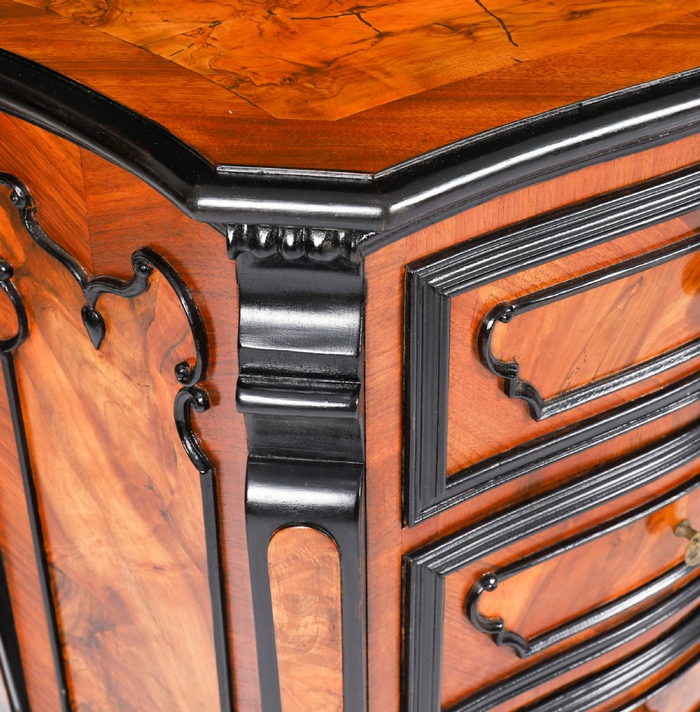 A pair of 18th-century Italian burr walnut serpentine bedside chests featuring ebonised mouldings, three drawers, and scroll feet. View X
