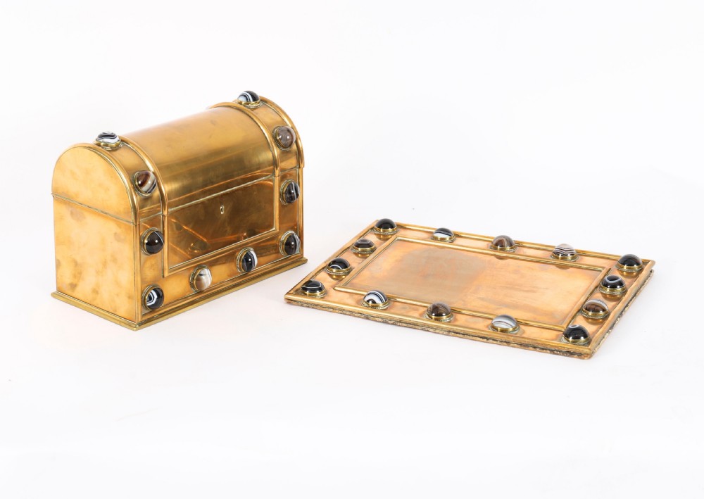 An antique mid-19th century English brass desk set featuring a domed casket and matching tray, both set with polished agate cabochons.