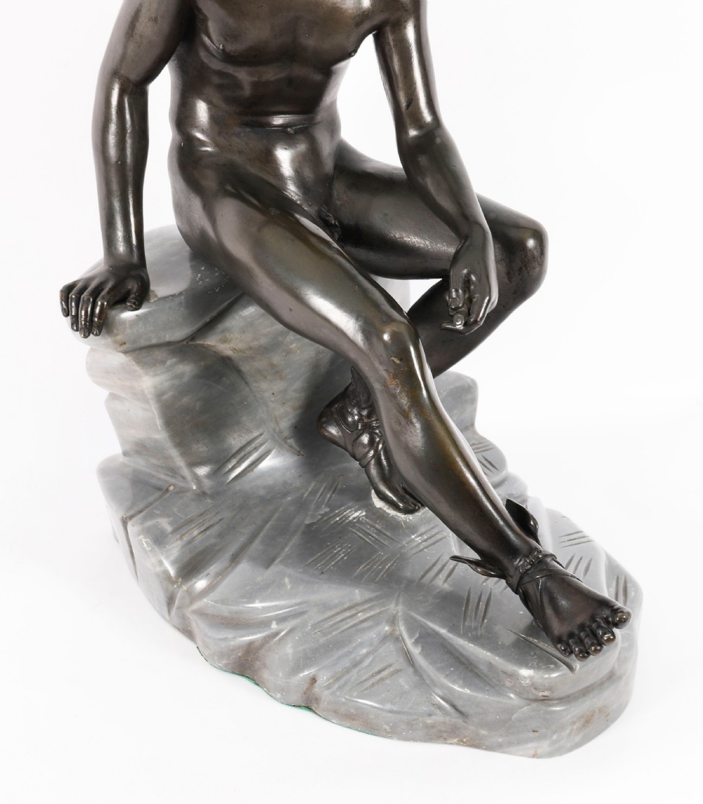 A dark patinated bronze sculpture depicting a nude seated Hermes resting on a carved grey marble base. View V