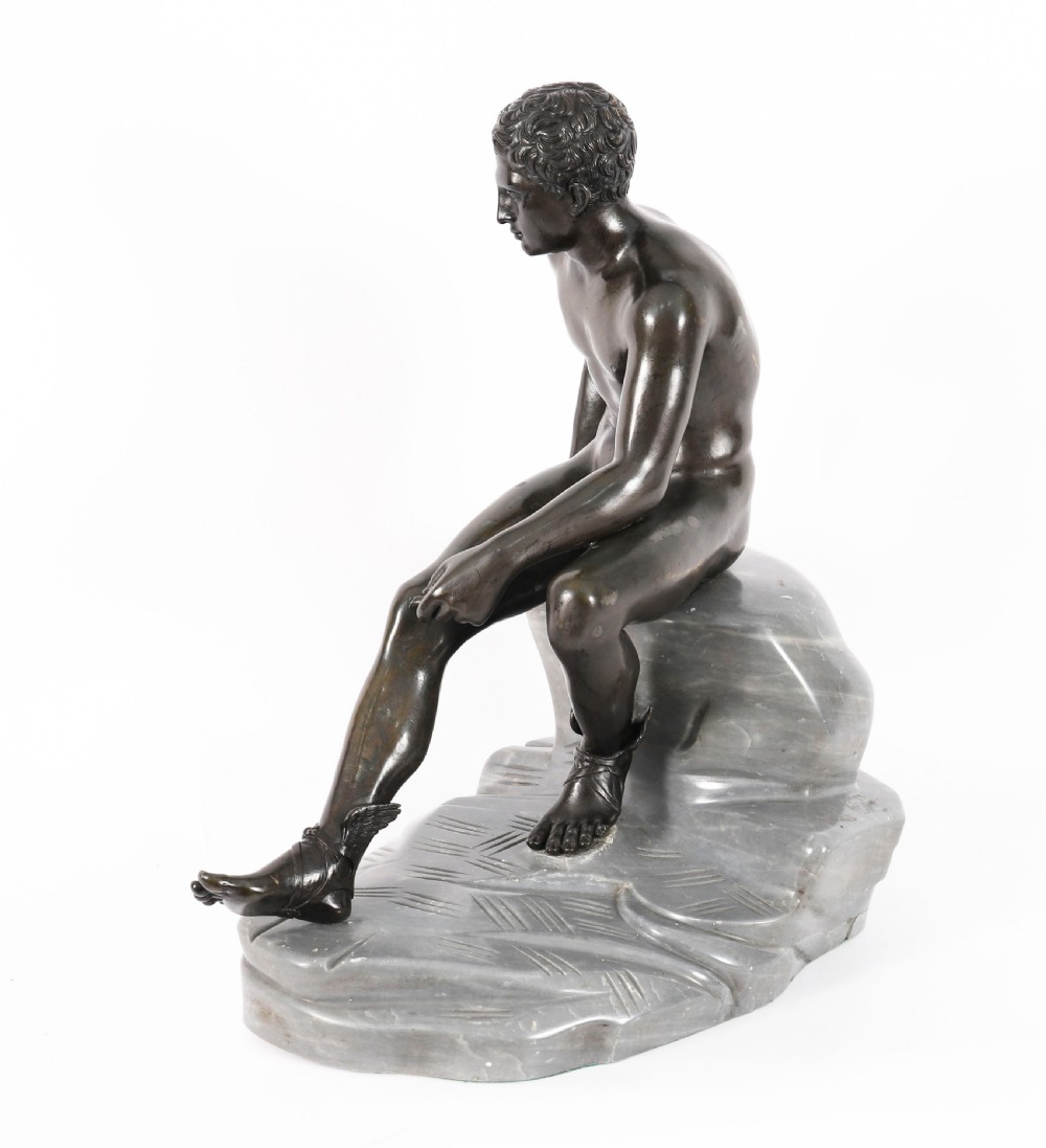 A dark patinated bronze sculpture depicting a nude seated Hermes resting on a carved grey marble base. View XI