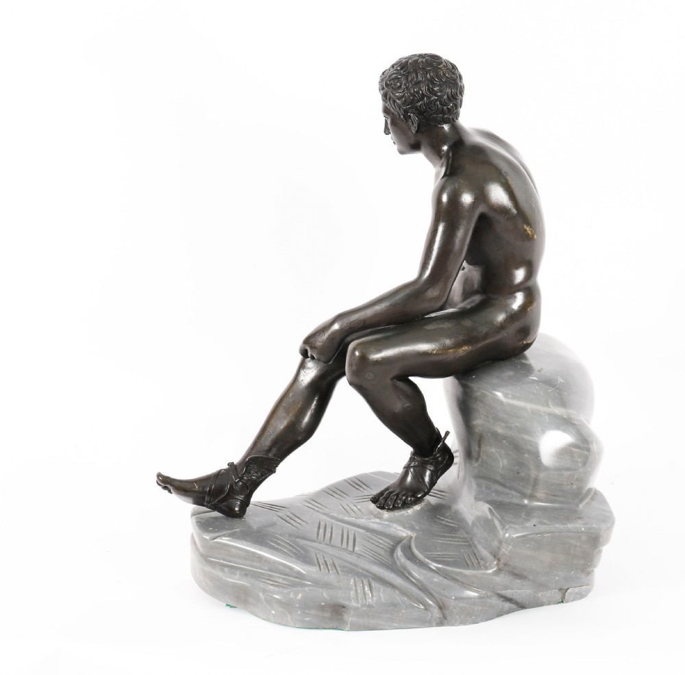 A dark patinated bronze sculpture depicting a nude seated Hermes resting on a carved grey marble base. View XVII