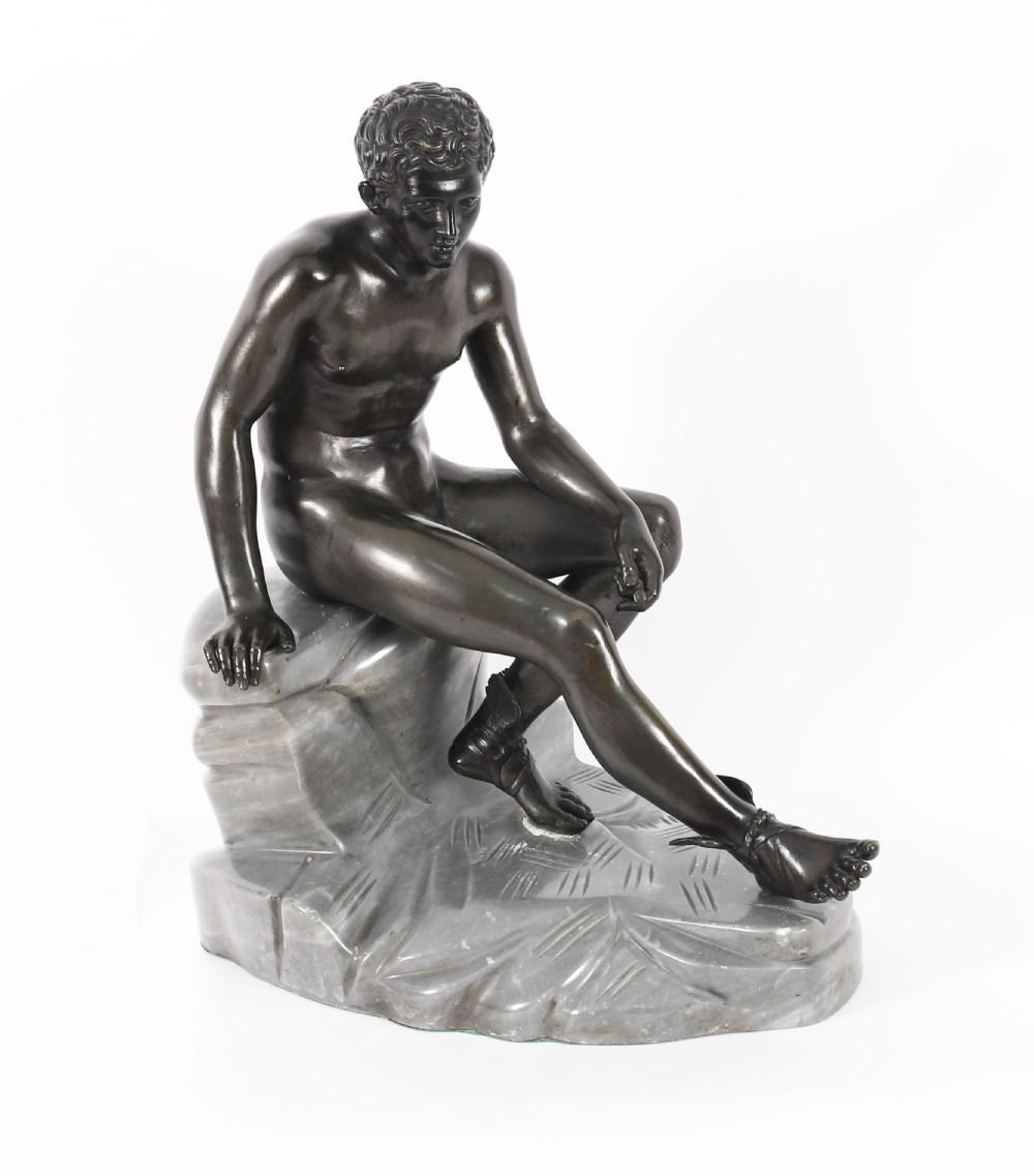 A dark patinated bronze sculpture depicting a nude seated Hermes resting on a carved grey marble base. View XVIII