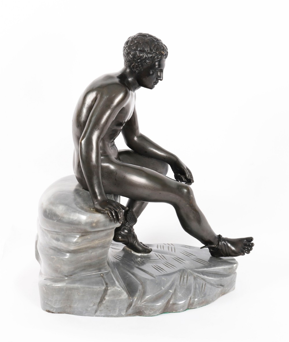 A dark patinated bronze sculpture depicting a nude seated Hermes resting on a carved grey marble base. View XIX