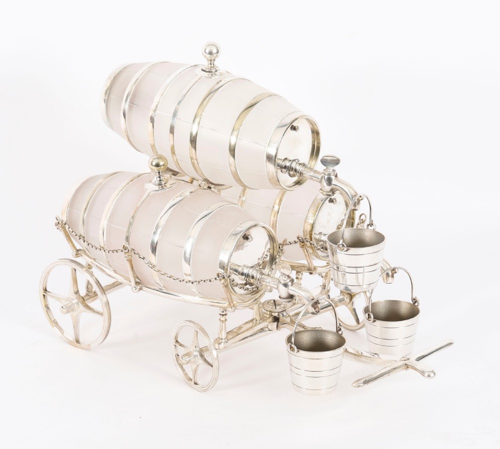 A 19th-century silver-plated carriage frame holding three frosted crystal barrels with taps and hanging miniature bucket tot cups. View III