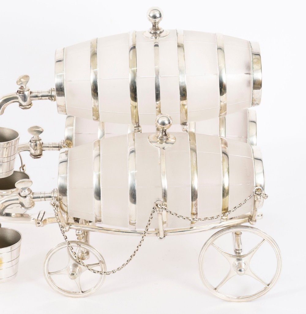 A 19th-century silver-plated carriage frame holding three frosted crystal barrels with taps and hanging miniature bucket tot cups. View IV
