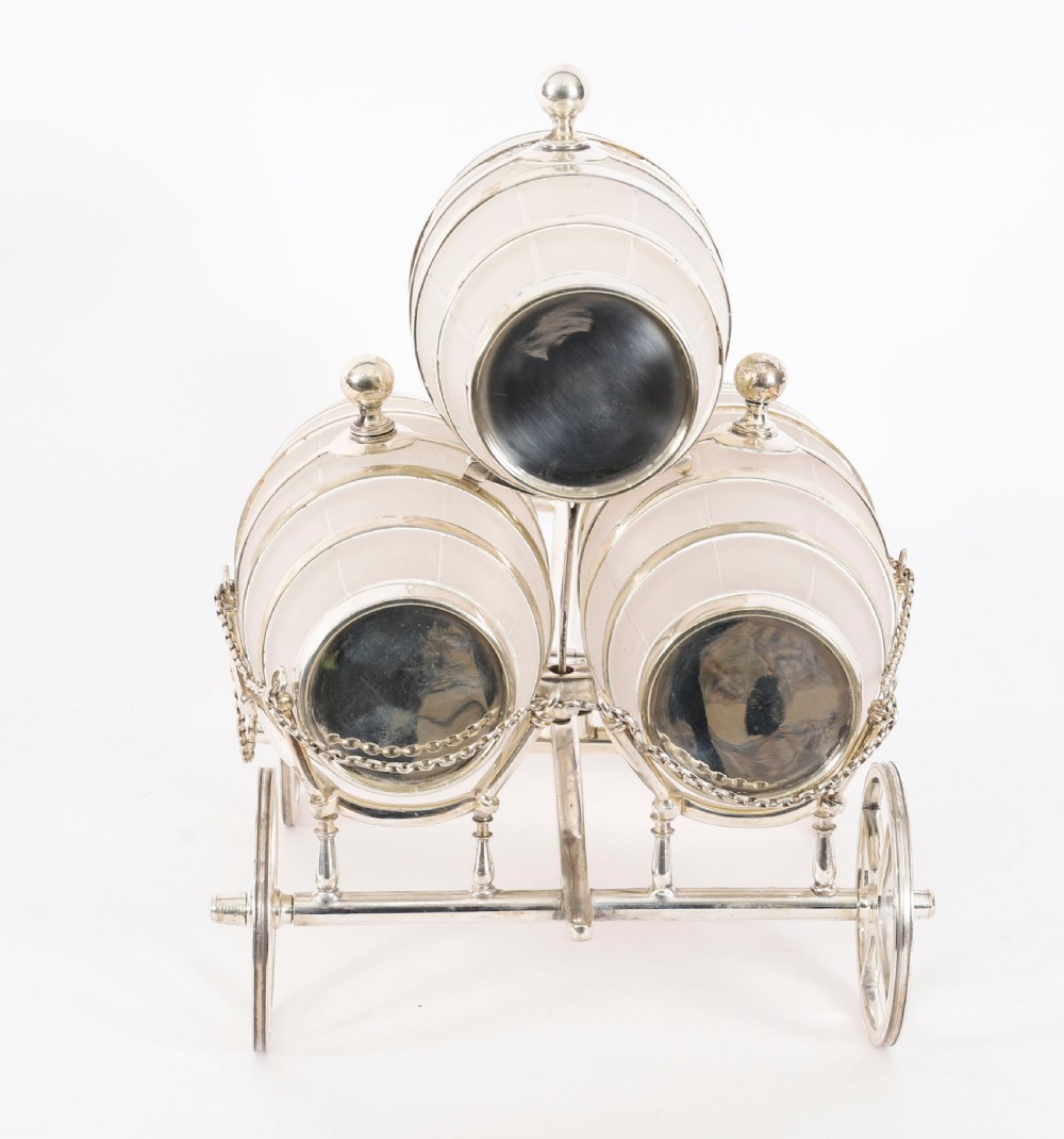 A 19th-century silver-plated carriage frame holding three frosted crystal barrels with taps and hanging miniature bucket tot cups. View VI