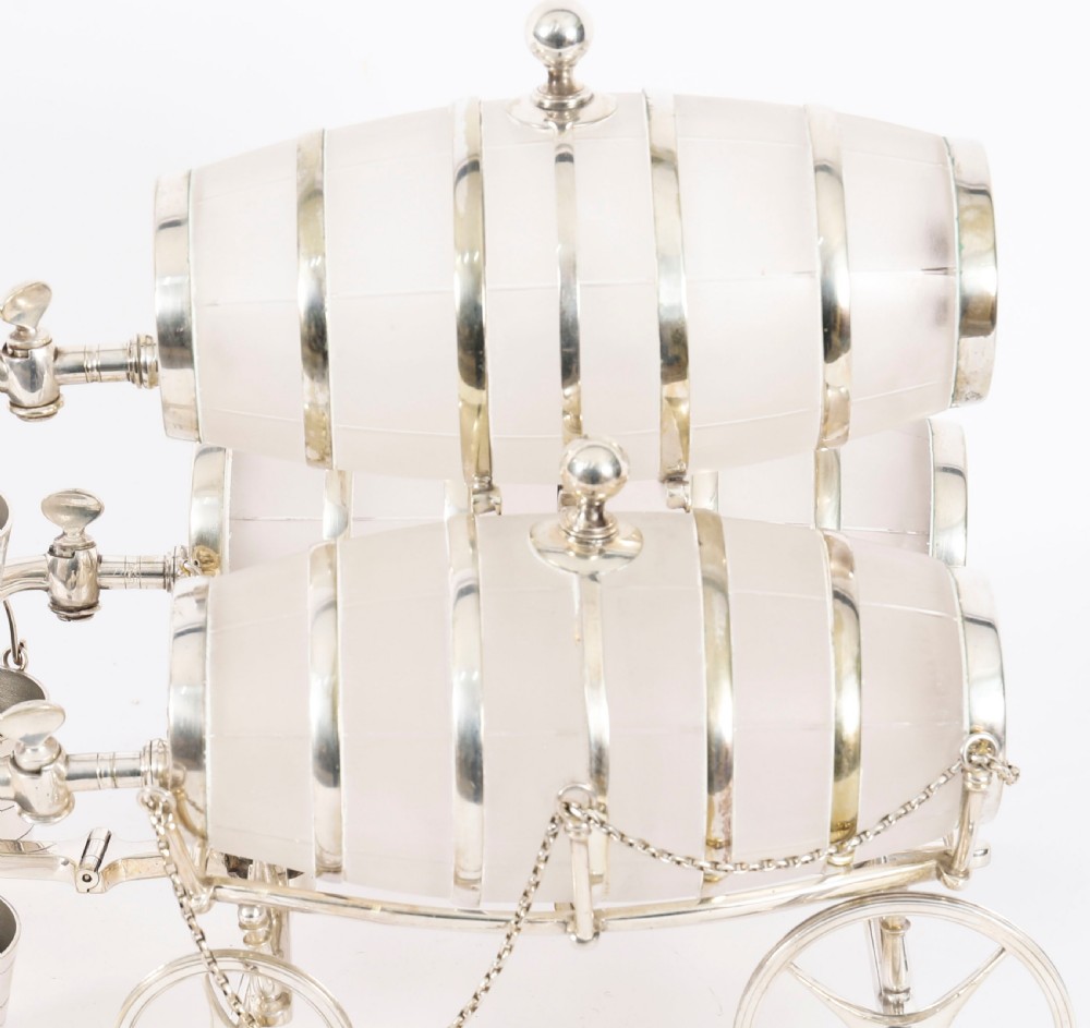 A 19th-century silver-plated carriage frame holding three frosted crystal barrels with taps and hanging miniature bucket tot cups. View VII