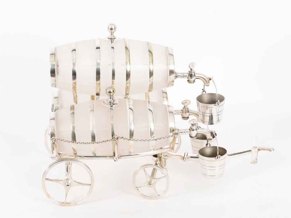 A 19th-century silver-plated carriage frame holding three frosted crystal barrels with taps and hanging miniature bucket tot cups. View VIII