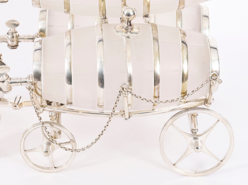 A 19th-century silver-plated carriage frame holding three frosted crystal barrels with taps and hanging miniature bucket tot cups. View XIII