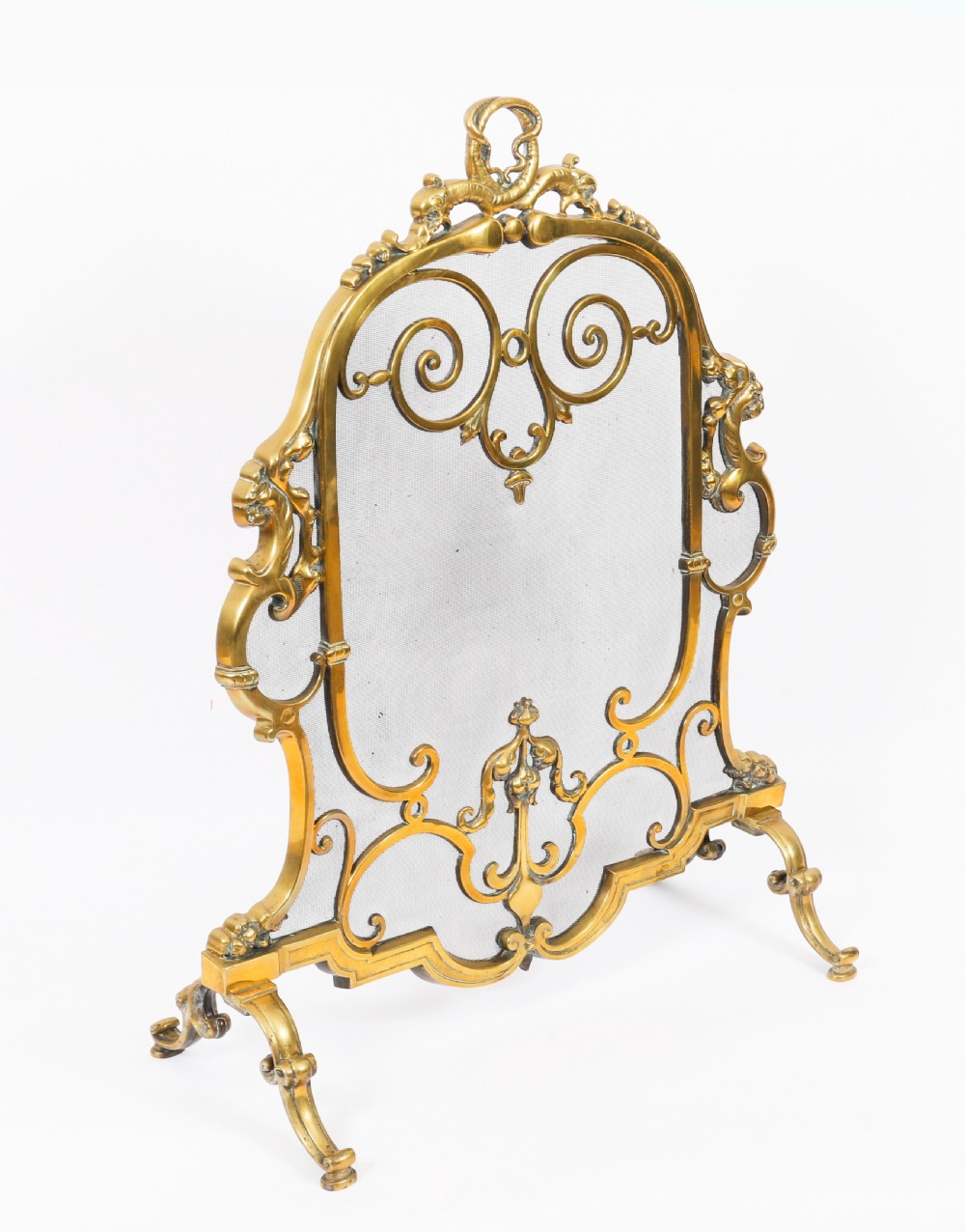 A nineteenth-century French Louis Revival brass fire screen featuring a wire mesh panel, scrollwork details, and dolphin motifs supported by four splayed feet.