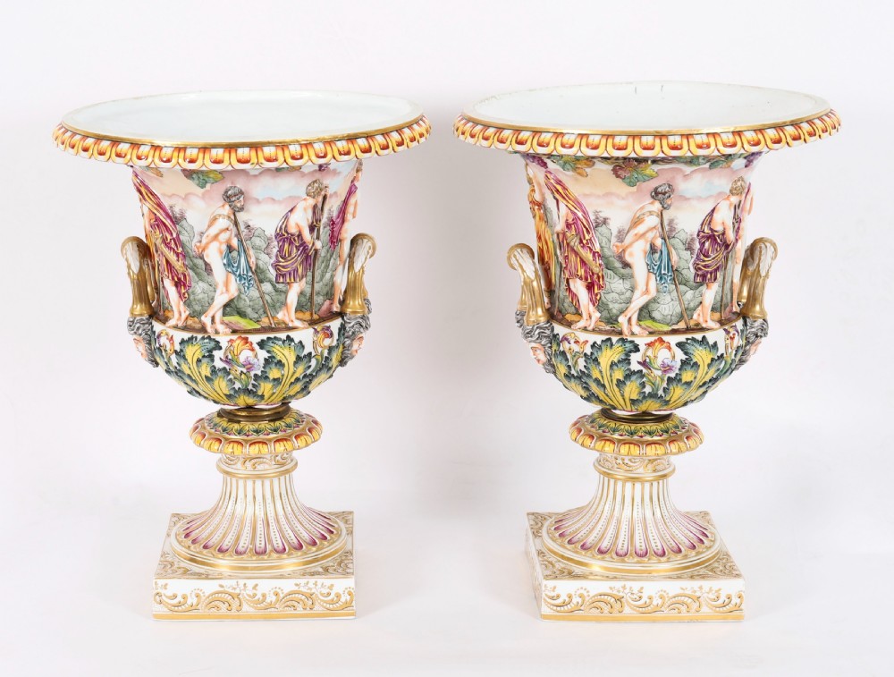 A 19th-century Capodimonte porcelain urn featuring classical figures in high relief, polychrome enamelling, gilded handles, and a square base. View II