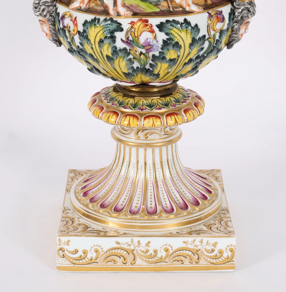 A 19th-century Capodimonte porcelain urn featuring classical figures in high relief, polychrome enamelling, gilded handles, and a square base. View III