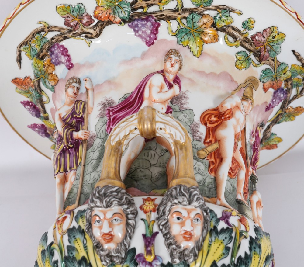 A 19th-century Capodimonte porcelain urn featuring classical figures in high relief, polychrome enamelling, gilded handles, and a square base. View VII