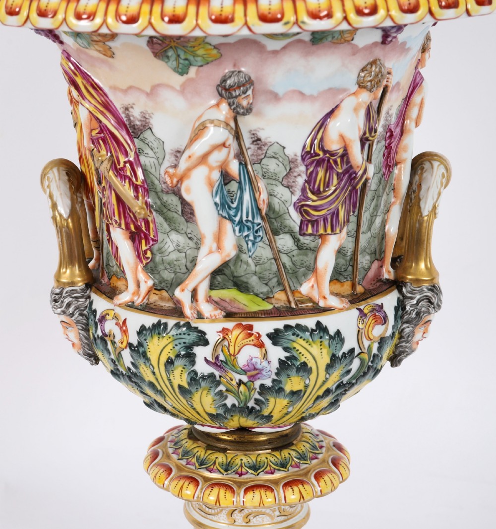 A 19th-century Capodimonte porcelain urn featuring classical figures in high relief, polychrome enamelling, gilded handles, and a square base. View VIII