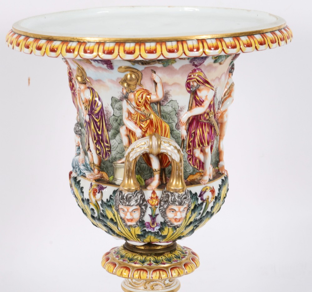 A 19th-century Capodimonte porcelain urn featuring classical figures in high relief, polychrome enamelling, gilded handles, and a square base. View XI