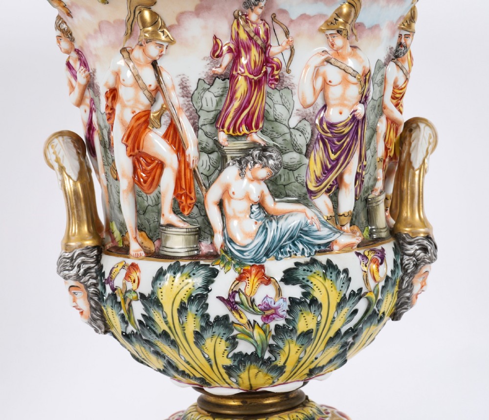 A 19th-century Capodimonte porcelain urn featuring classical figures in high relief, polychrome enamelling, gilded handles, and a square base. View XV