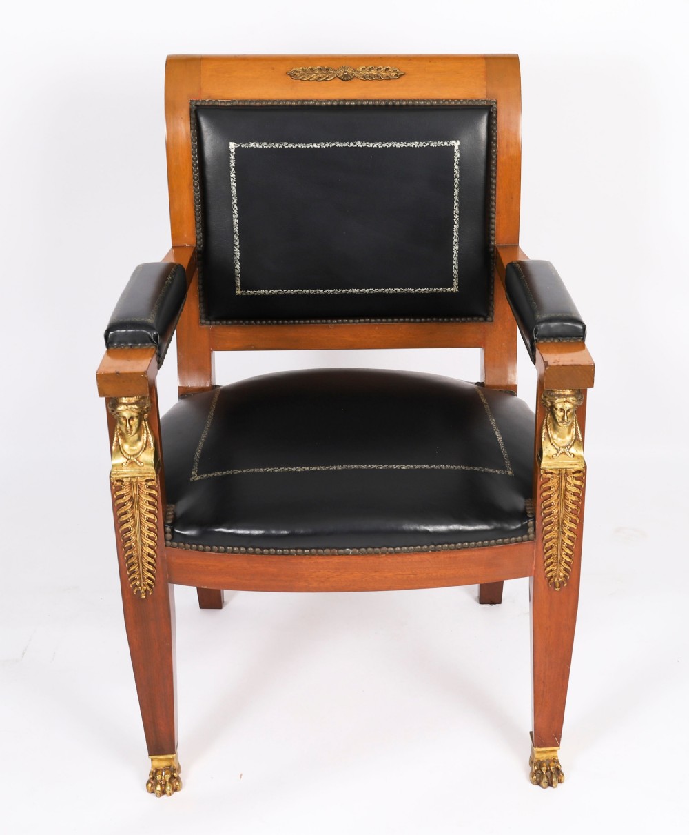 A nineteenth-century French Empire desk chair with black leather upholstery, mahogany frame, and gilt-bronze caryatid mounts. View II