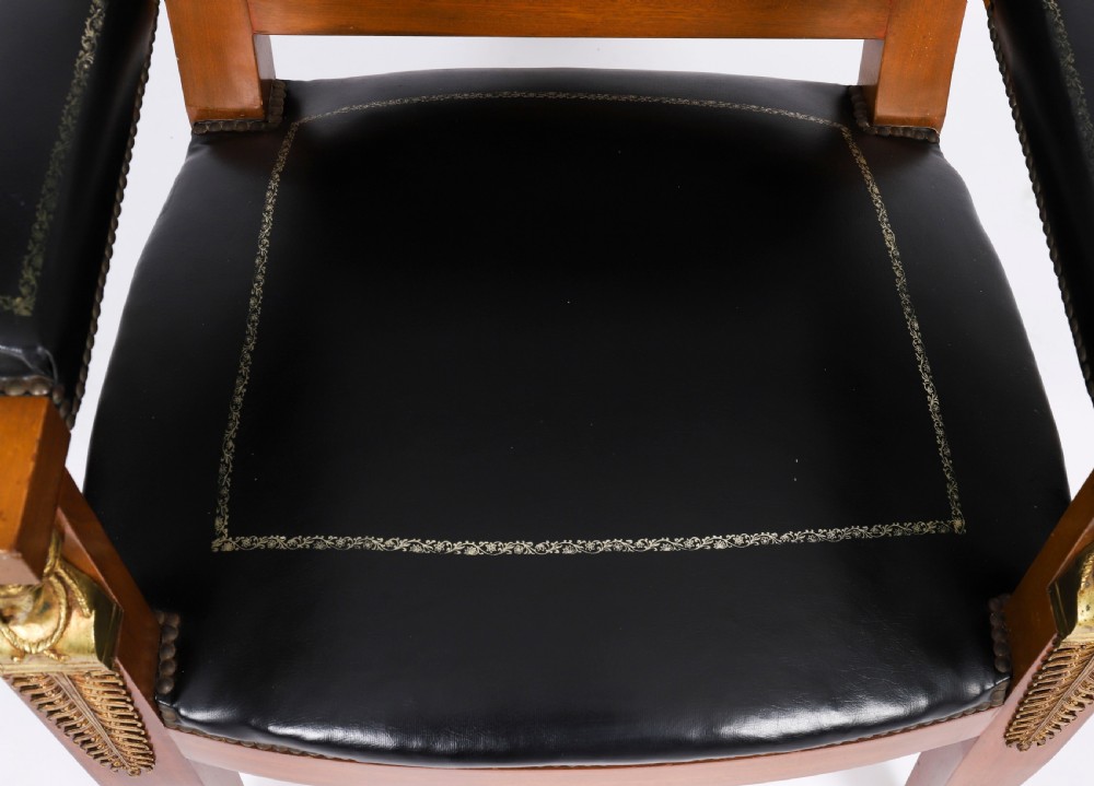 A nineteenth-century French Empire desk chair with black leather upholstery, mahogany frame, and gilt-bronze caryatid mounts. View VI