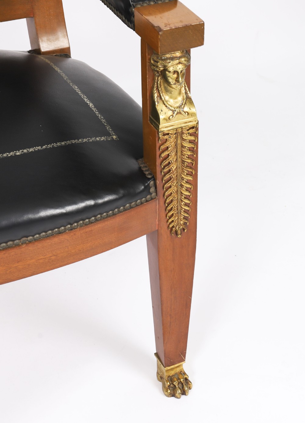 A nineteenth-century French Empire desk chair with black leather upholstery, mahogany frame, and gilt-bronze caryatid mounts. View IX
