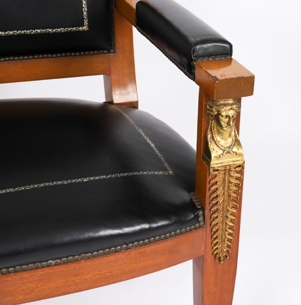 A nineteenth-century French Empire desk chair with black leather upholstery, mahogany frame, and gilt-bronze caryatid mounts. View XI