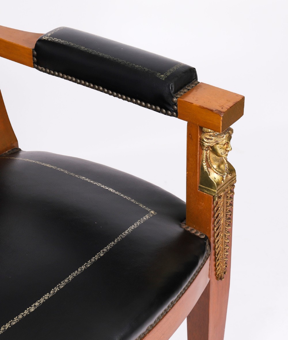 A nineteenth-century French Empire desk chair with black leather upholstery, mahogany frame, and gilt-bronze caryatid mounts. View XIII