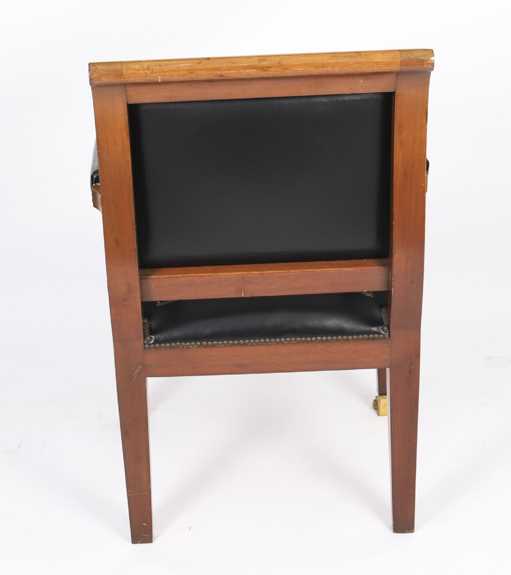 A nineteenth-century French Empire desk chair with black leather upholstery, mahogany frame, and gilt-bronze caryatid mounts. View XV