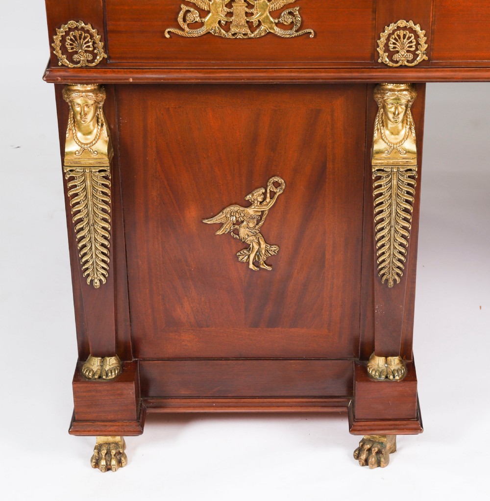 A French Empire style mahogany pedestal desk featuring a green leather top insert, decorative gilt-bronze mounts, and caryatid corner supports. View IV