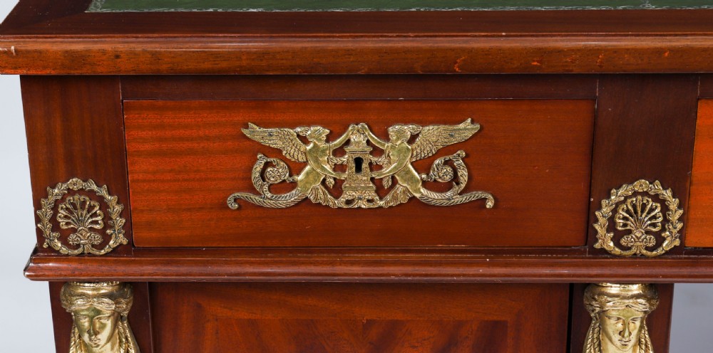 A French Empire style mahogany pedestal desk featuring a green leather top insert, decorative gilt-bronze mounts, and caryatid corner supports. View XII