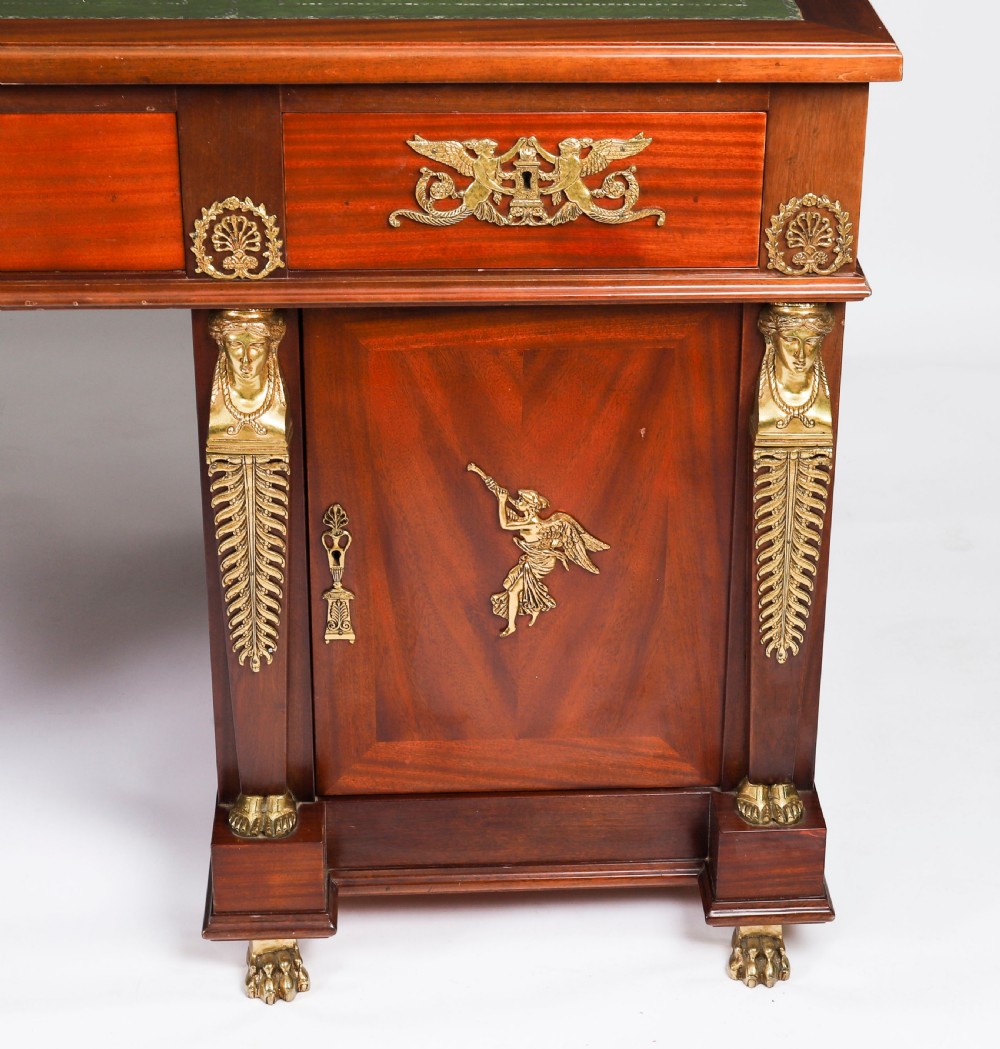 A French Empire style mahogany pedestal desk featuring a green leather top insert, decorative gilt-bronze mounts, and caryatid corner supports. View XIII