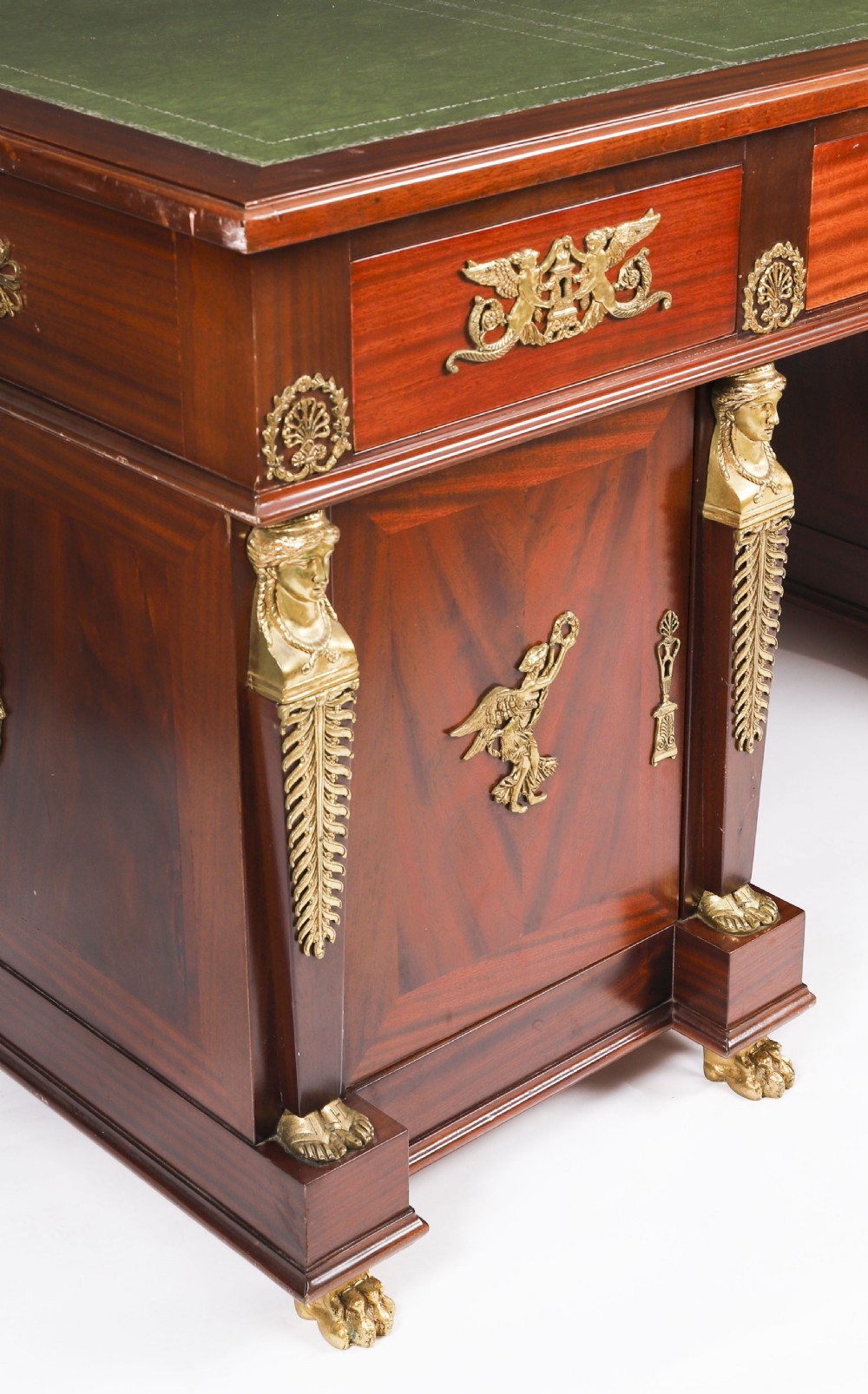 A French Empire style mahogany pedestal desk featuring a green leather top insert, decorative gilt-bronze mounts, and caryatid corner supports. View XIV